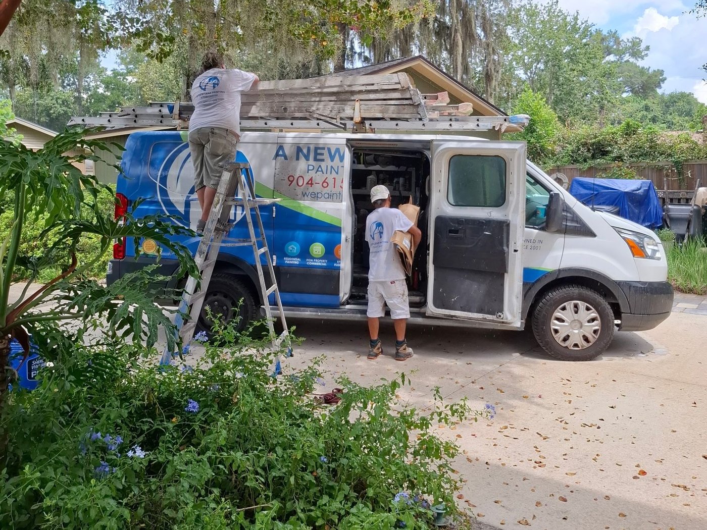 Two A New Leaf painters loading the company van