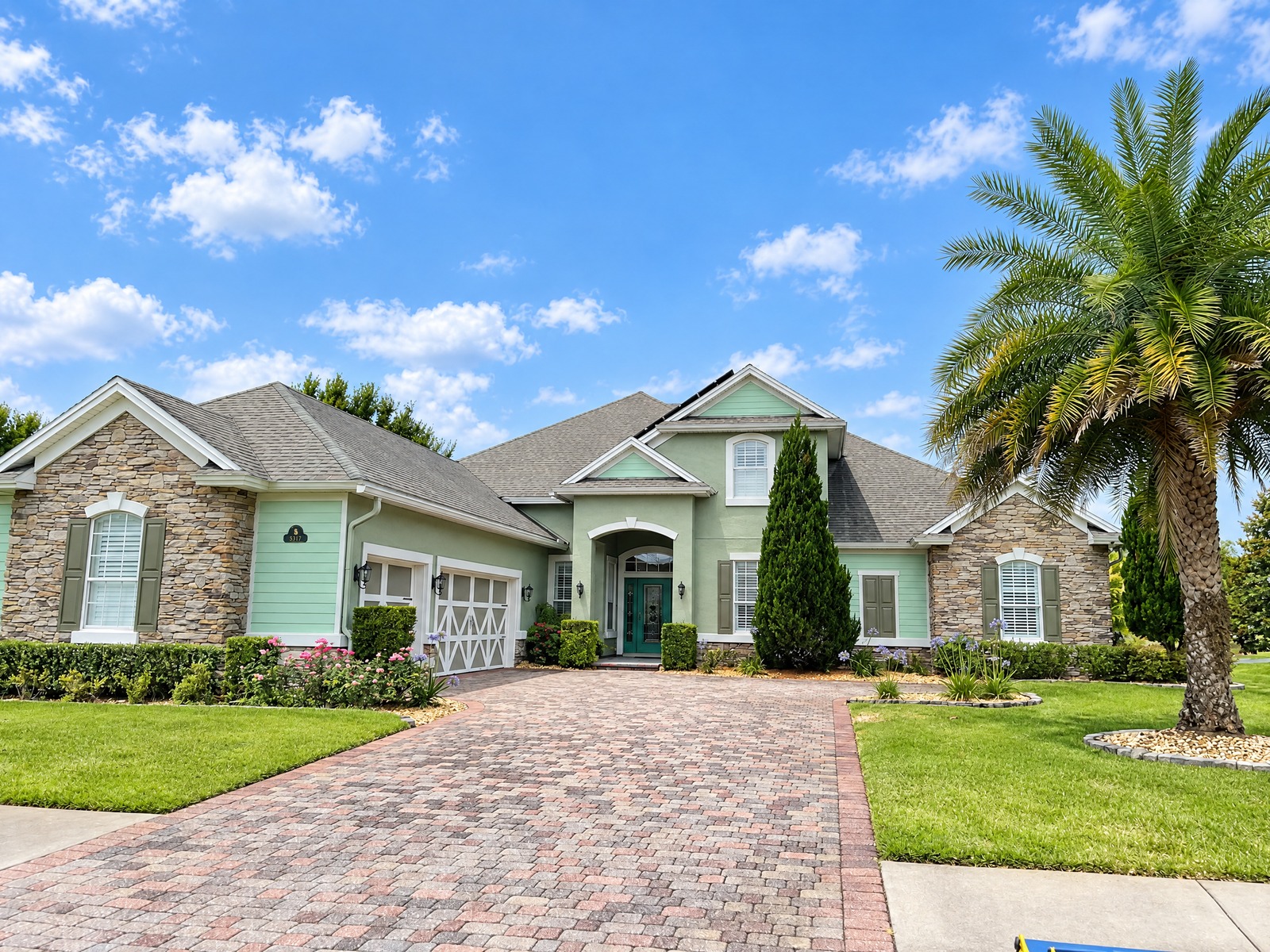 Two-storey home with stone and siding after exterior painting in Jacksonville, FL 32226