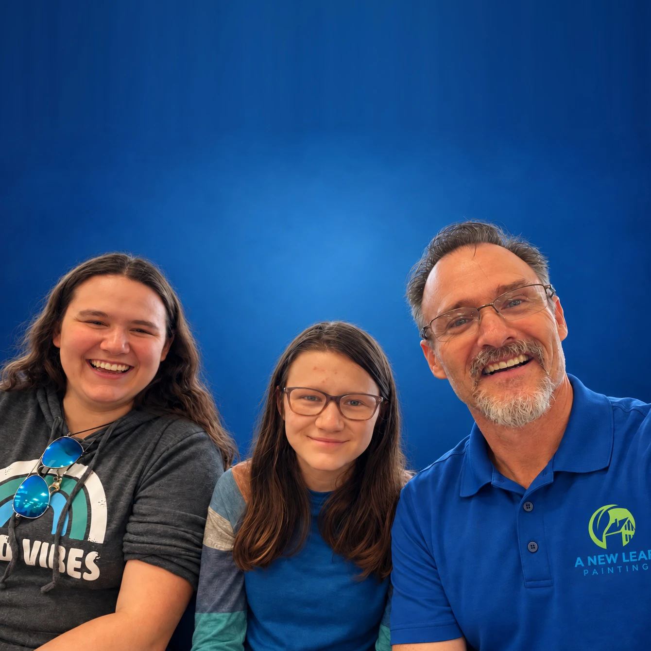Thomas Drake, owner of A New Leaf Painting, with his two daughters