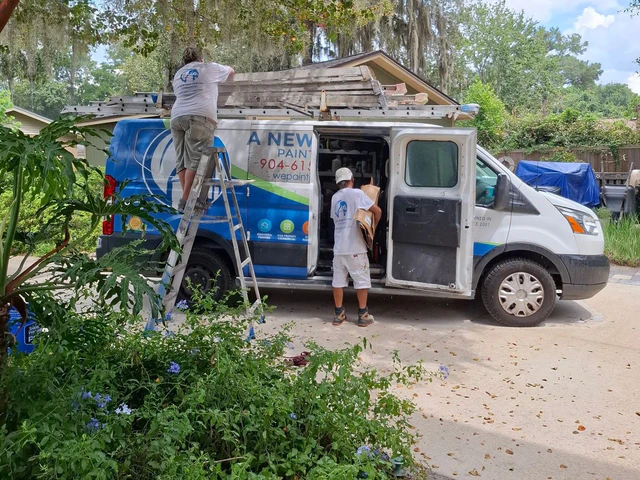Two A New Leaf painters loading the company van