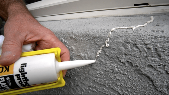 Caulking stucco cracks before painting